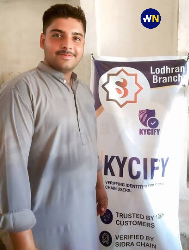 Man standing beside a Sidra Chain physical KYC banner at the Lodhran branch, highlighting the KYCIFY identity verification service.